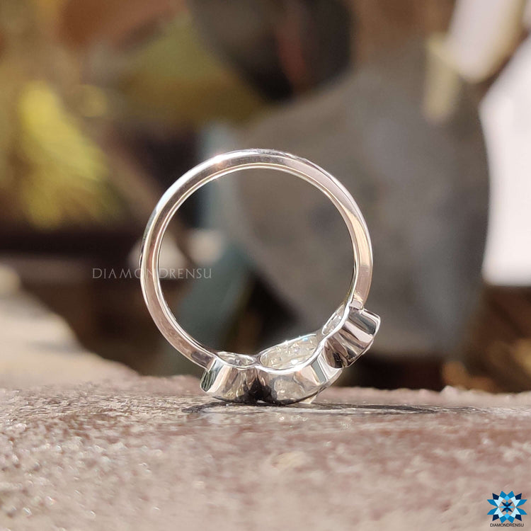 Custom engagement ring with three bezel set stones.
