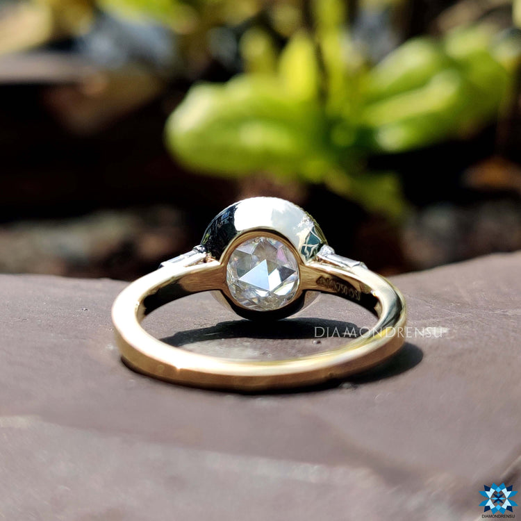 Bullet cut side stones on two tone engagement ring.

