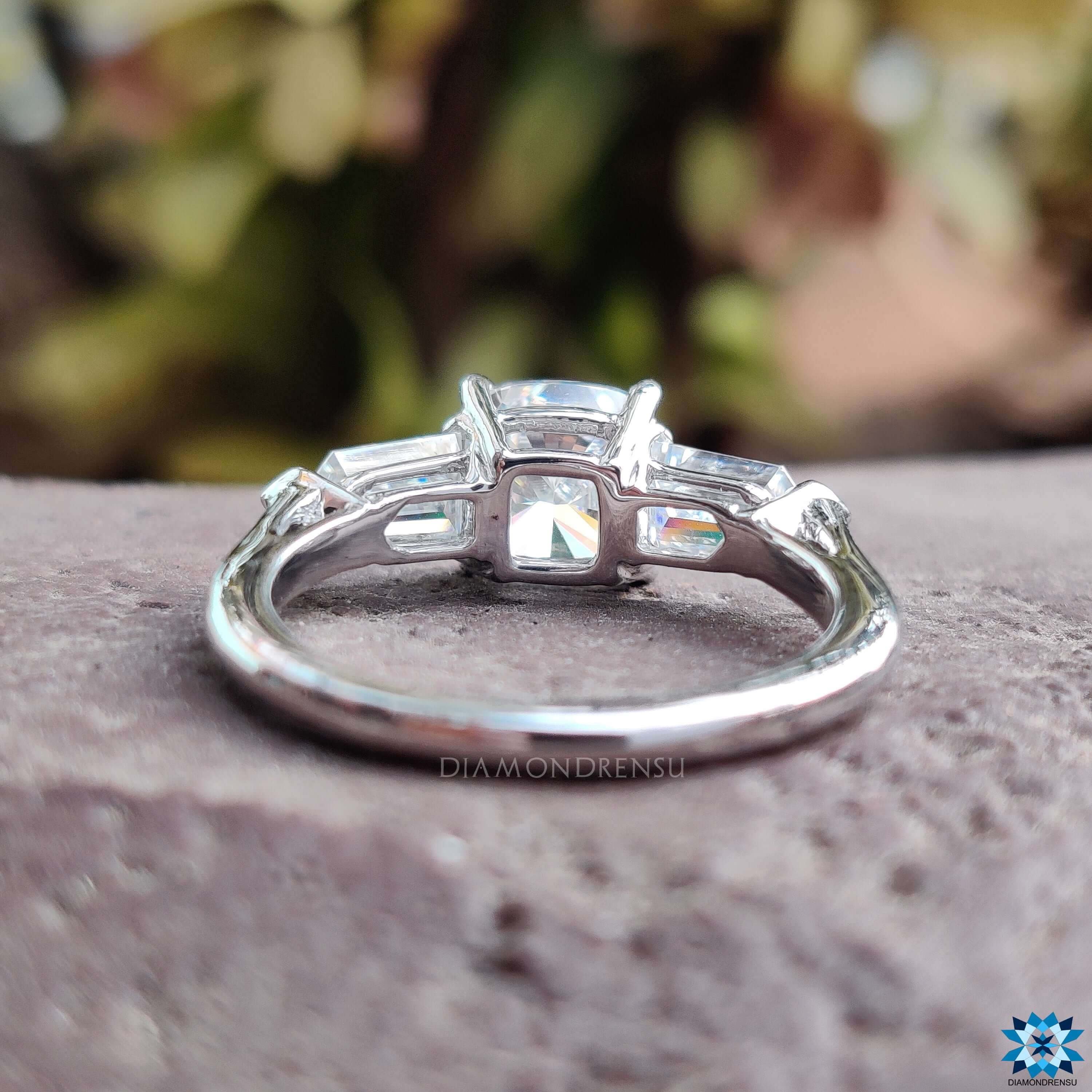 4 prong claw setting holding the moissanite stones in a beautiful three stone engagement ring.