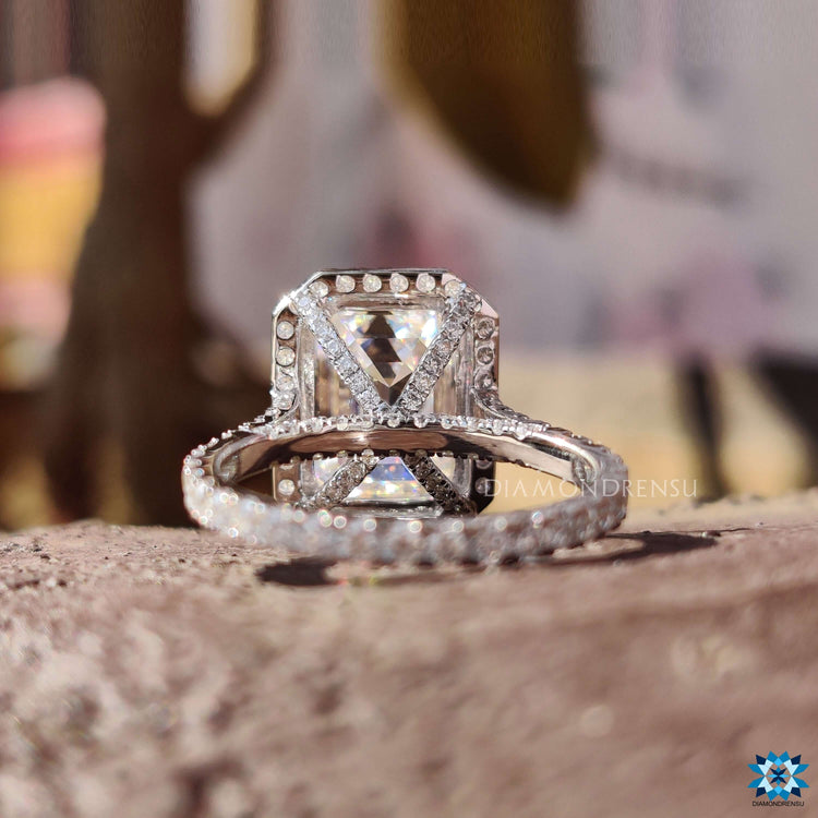 Handmade engagement ring with emerald and round cut stones.
