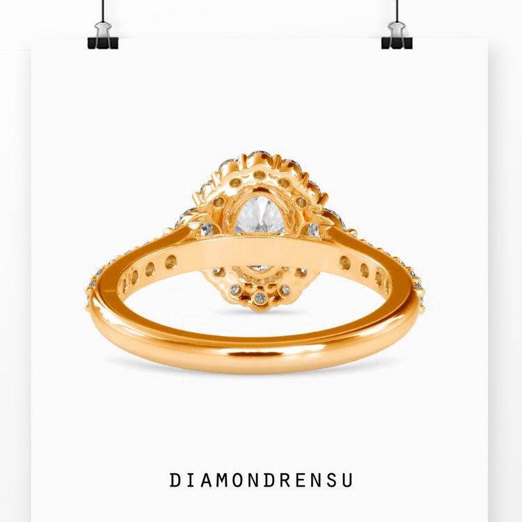 Handmade ring featuring oval diamond and round cut pave band.
