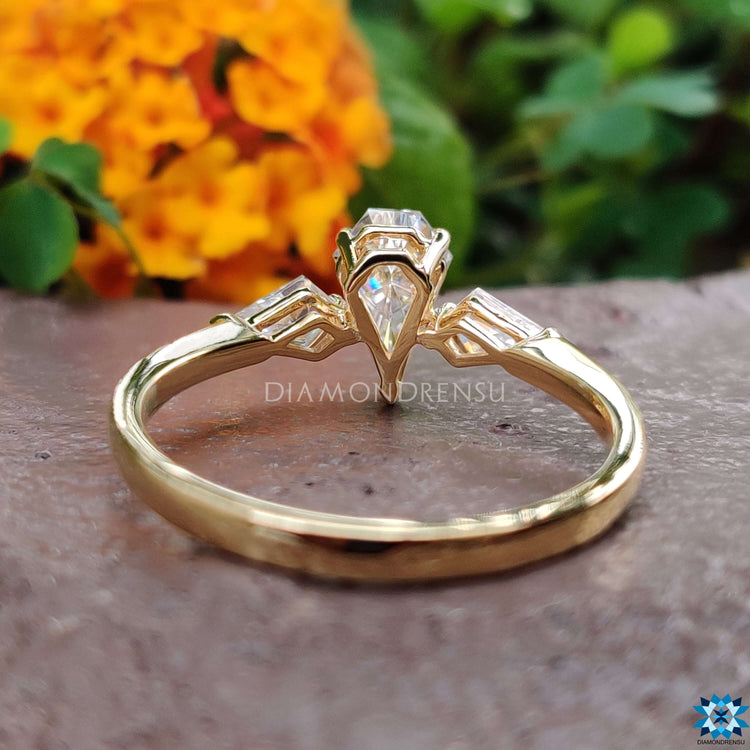 Moissanite ring featuring V and round prong settings.
