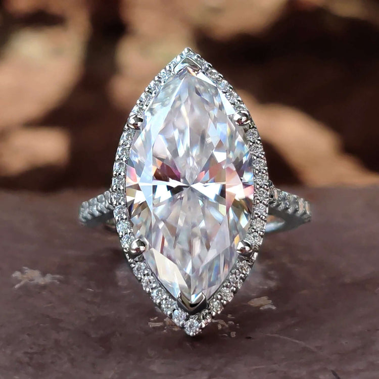 Marquise halo engagement ring with white gold band.
