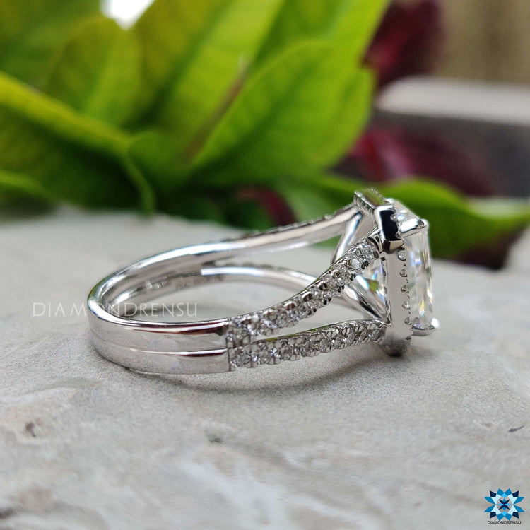 Moissanite radiant ring with round cut accents.
