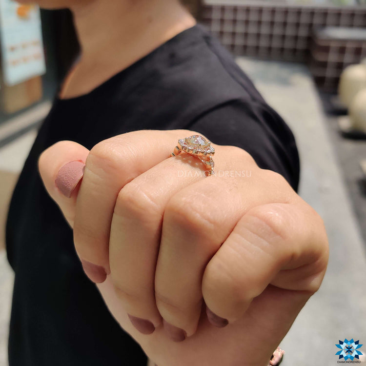 Round engagement ring with off white moissanite center.
