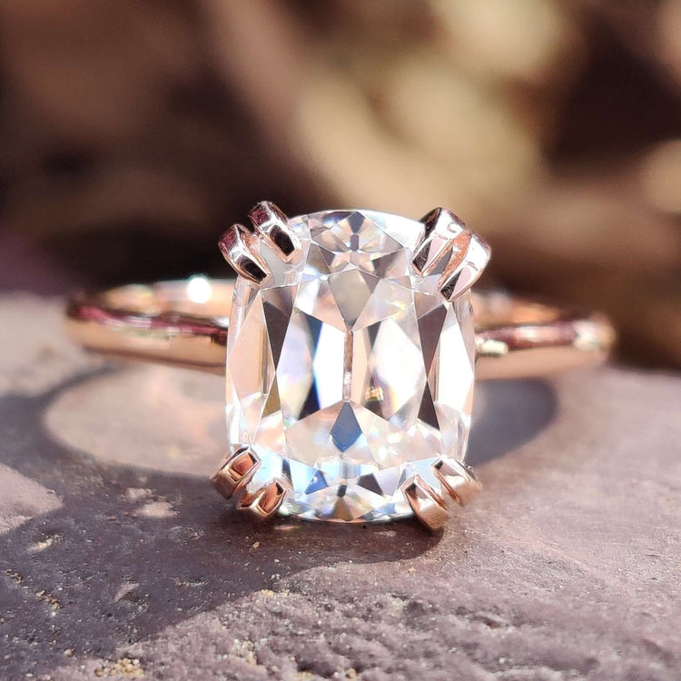 Elongated cushion old European cut moissanite ring in rose gold.

