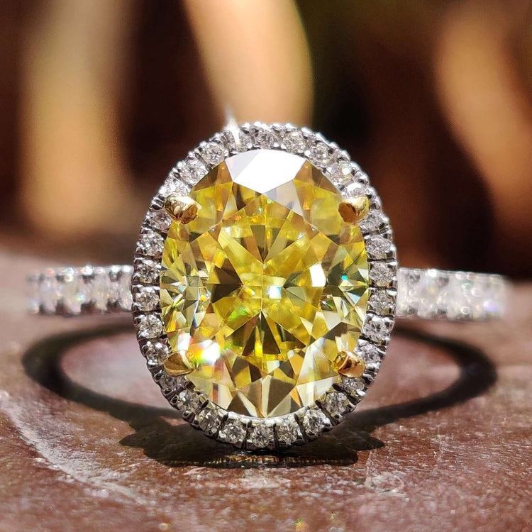 canary yellow oval cut engagement ring with halo setting.