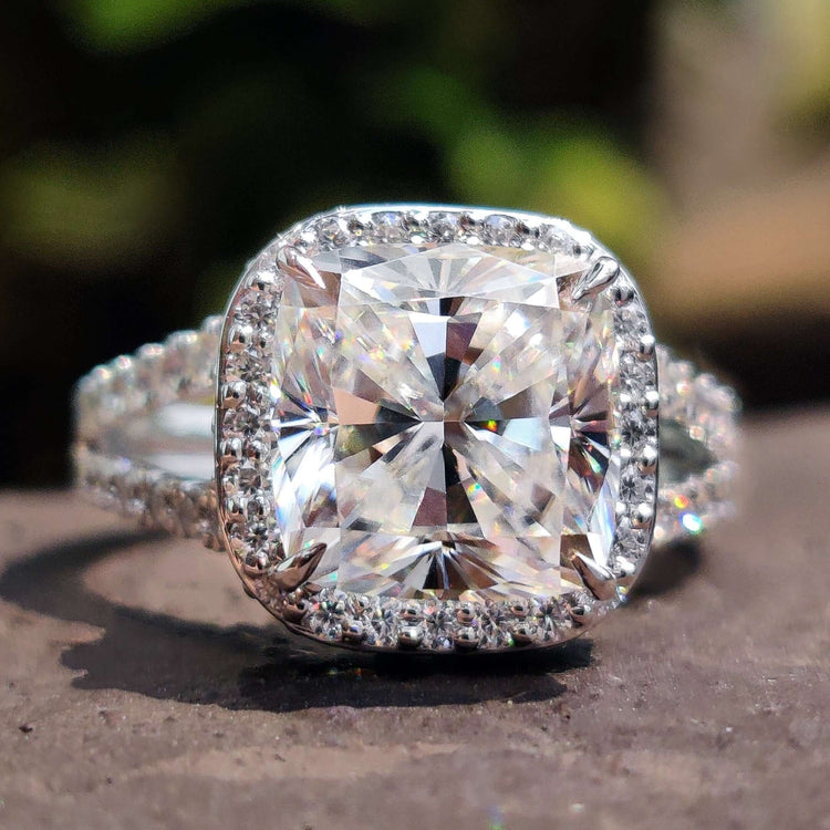 Cushion cut moissanite engagement ring with hidden halo in white gold.

