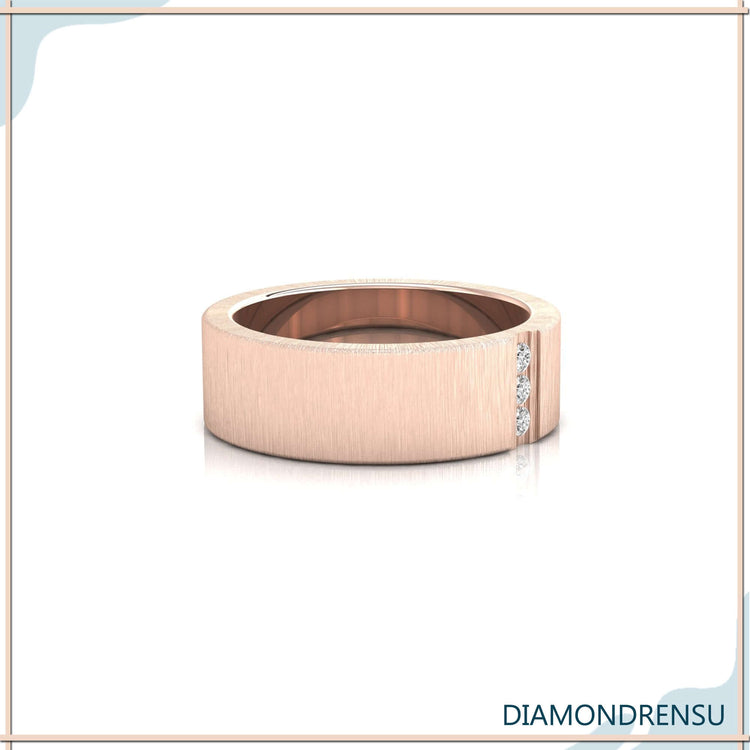 Three stone diamond wedding band in brushed finish with yellow gold.
