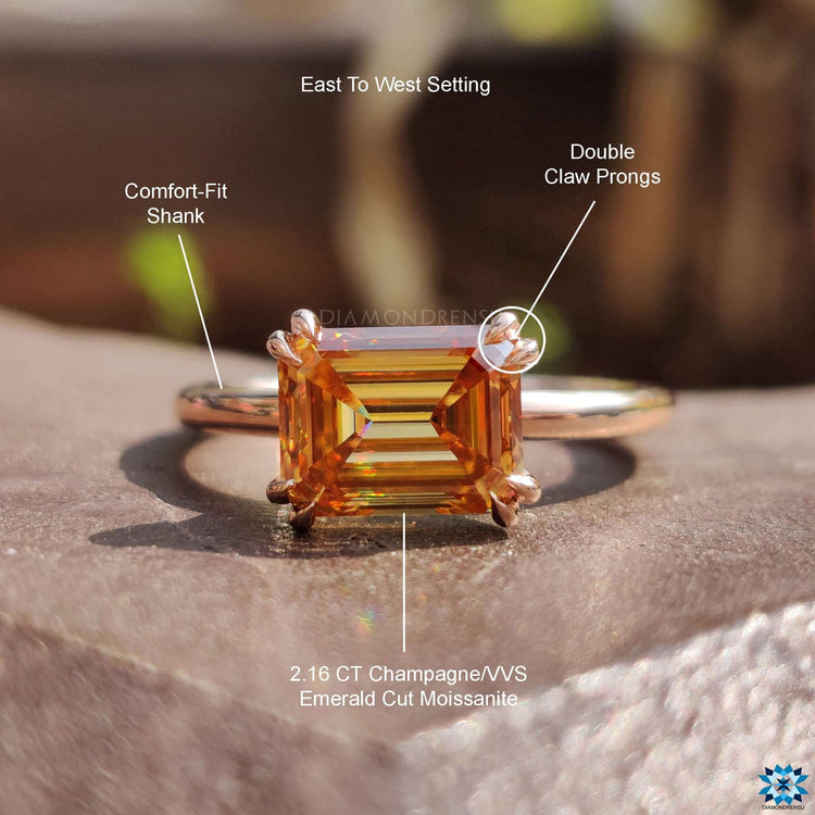 Emerald cut moissanite ring in solitaire setting.
