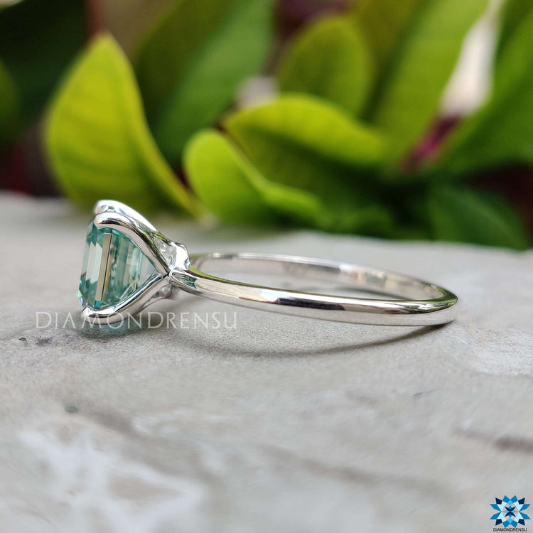 Custom blue moissanite engagement ring in solitaire setting.
