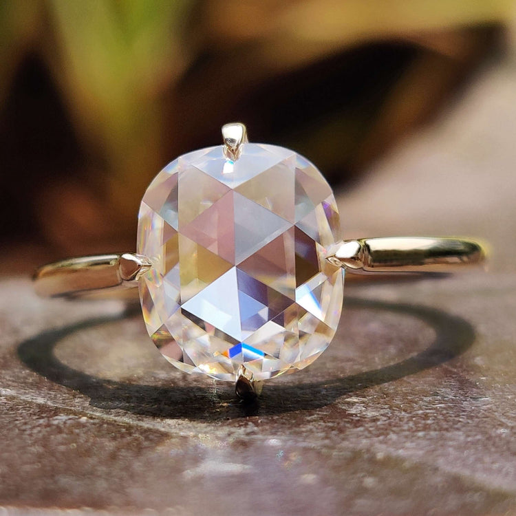 Cushion cut rose moissanite ring in yellow gold.
