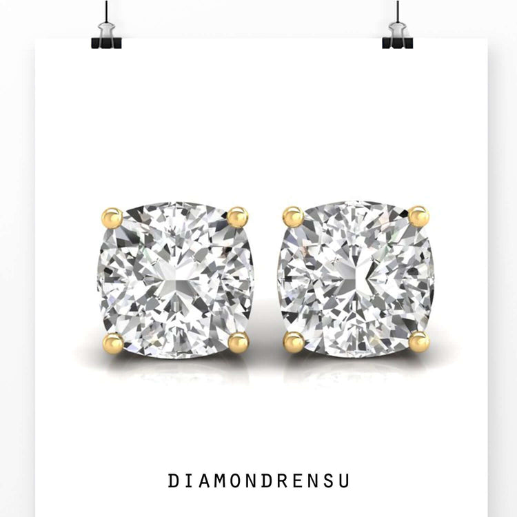 Gold stud earrings featuring lab grown diamonds.
