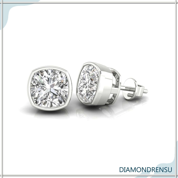 Diamond stud earrings with cushion cut stones in rose gold bezel.
