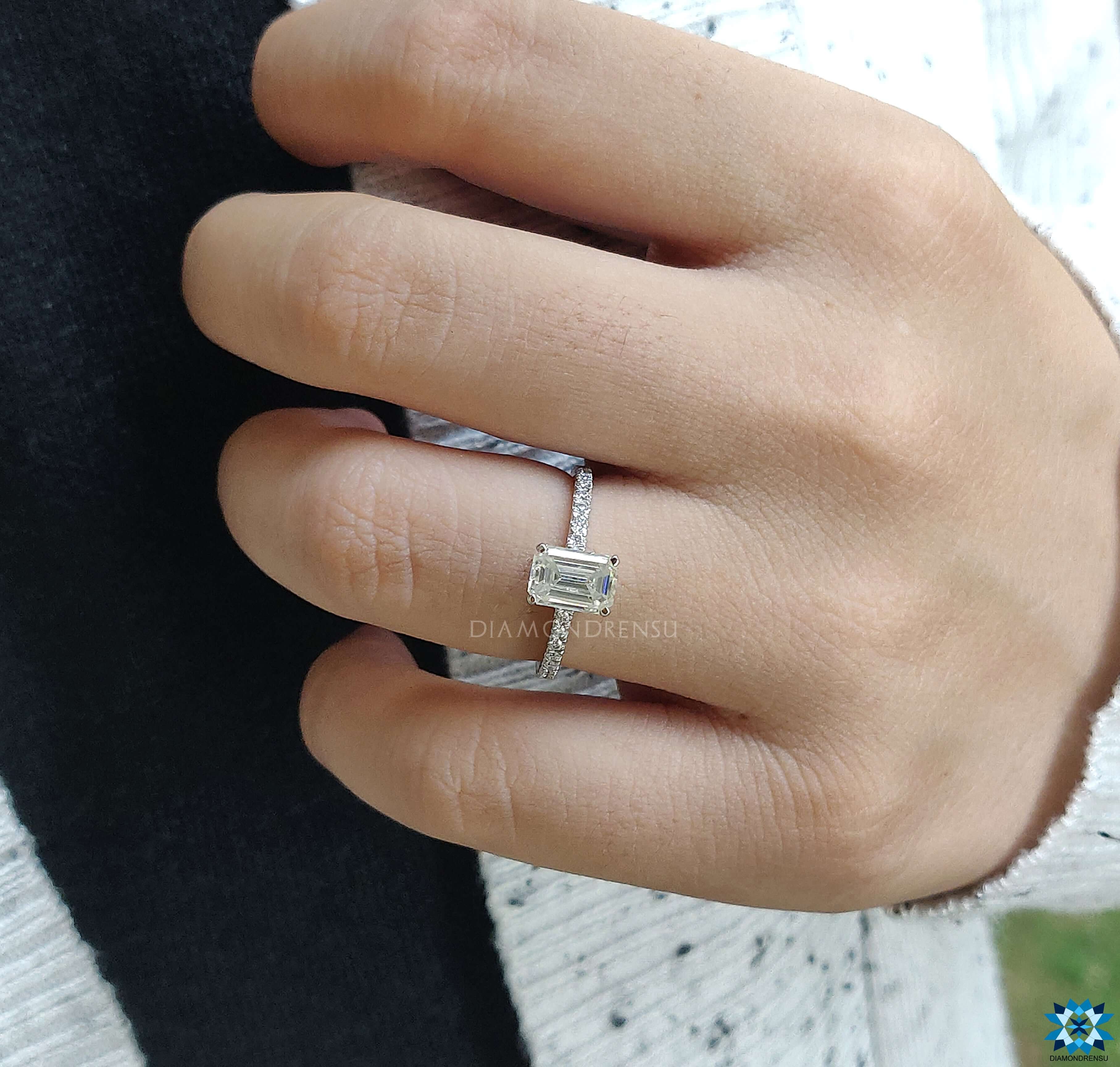 Hidden halo moissanite ring with a beautiful emerald cut moissanite.