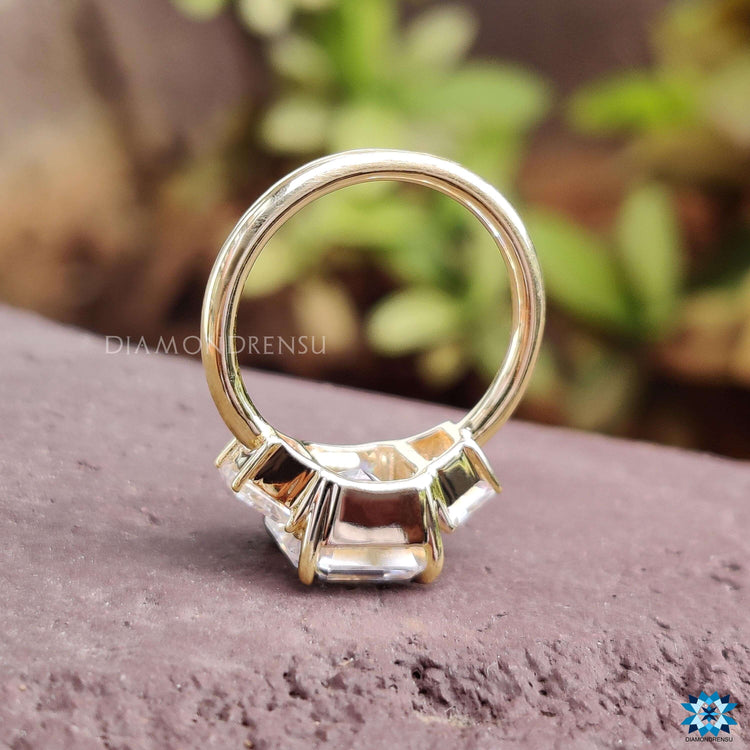 Handmade 3 stone moissanite ring in yellow gold.
