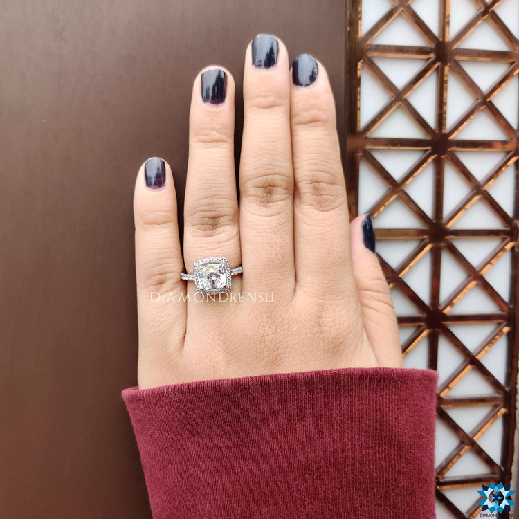 Diamondrensu UK cushion moissanite ring in cathedral setting.

