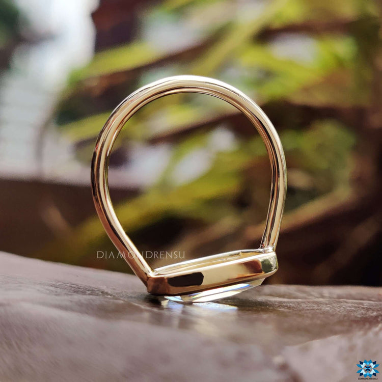 Moissanite solitaire ring with bezel setting.
