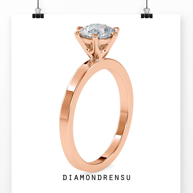 Solitaire diamond ring featuring 6 prongs in yellow gold.
