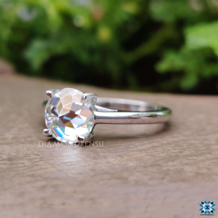 Solitaire engagement ring featuring round rose cut stone.

