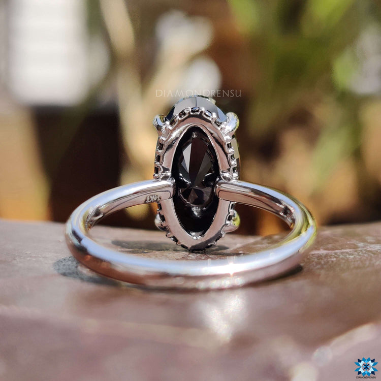Round cut hidden halo setting in white gold.
