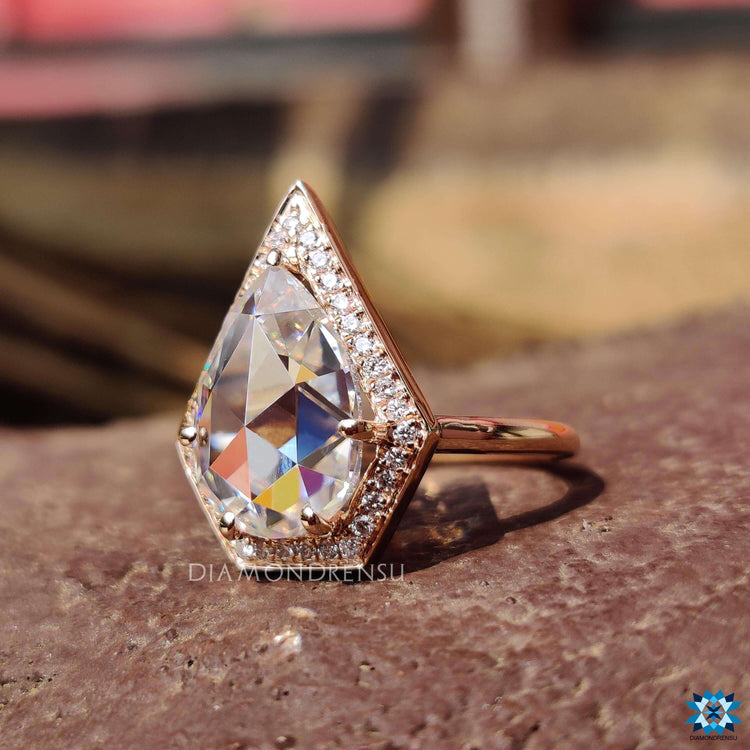 Custom engagement ring with pear halo design.

