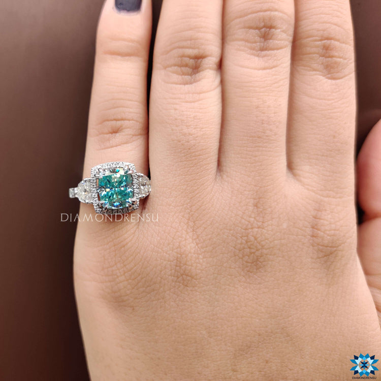 Handmade ring with blue moissanite and vintage-inspired design.

