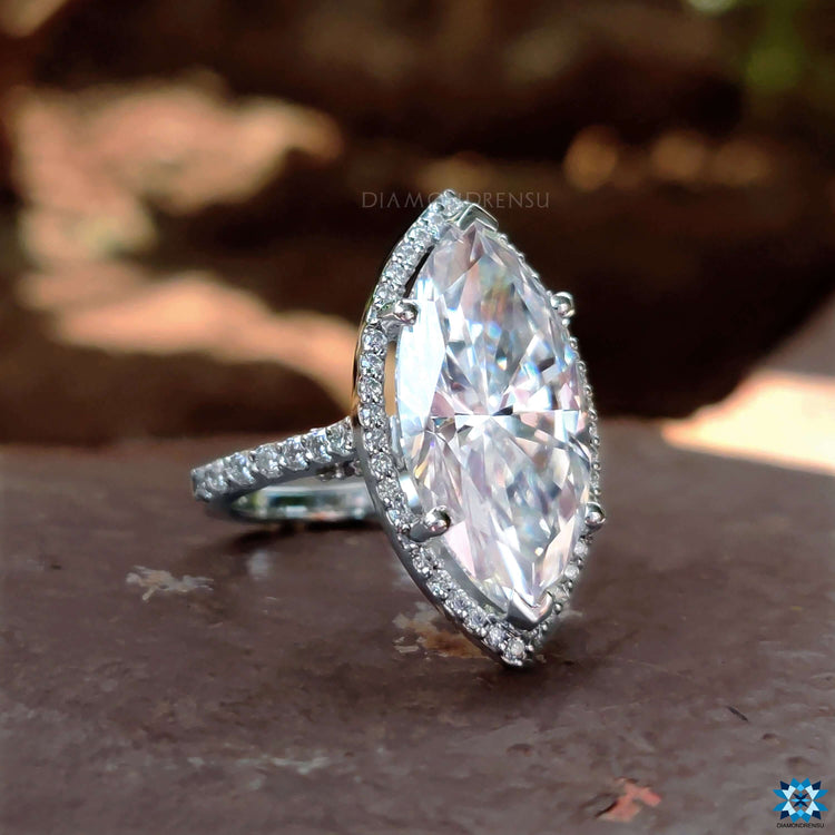 Moissanite halo ring with marquise shaped center.

