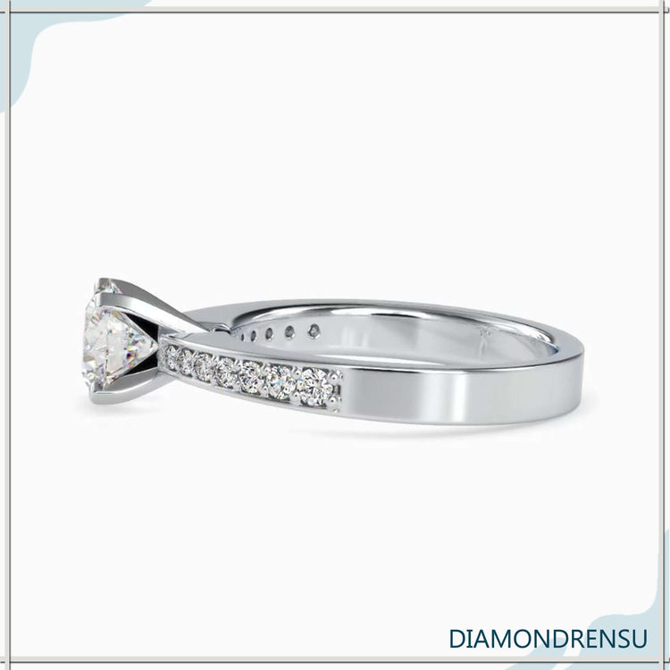 Rose gold engagement ring with channel set diamonds and a romantic finish.
