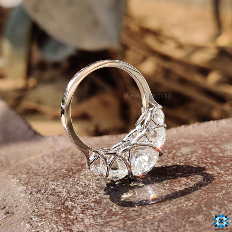White gold engagement ring featuring five moissanite stones.
