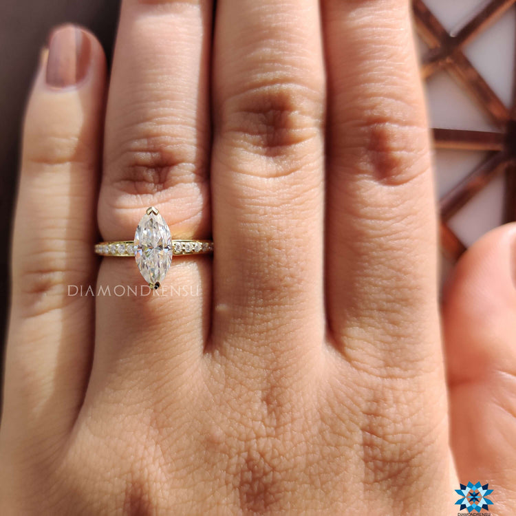 Pave setting engagement ring with hidden halo marquise stone.
