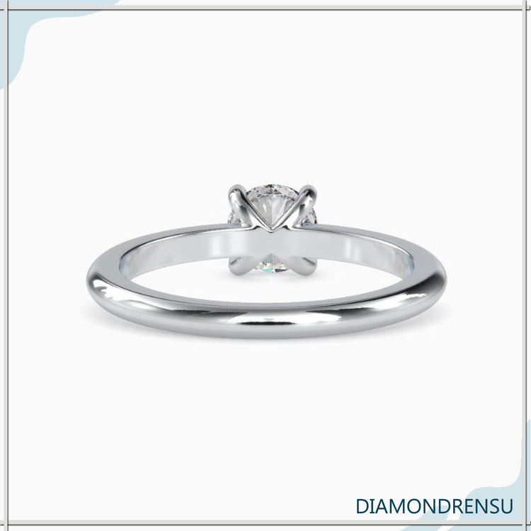 Custom design ring with solitaire prong setting and white gold finish.
