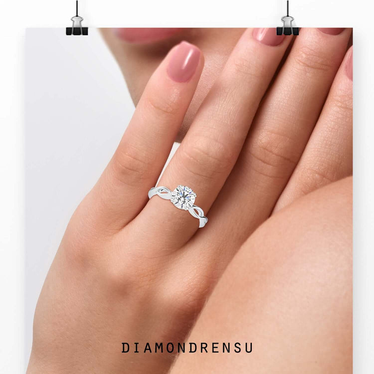 Twist engagement ring in rose gold with heart prong setting.

