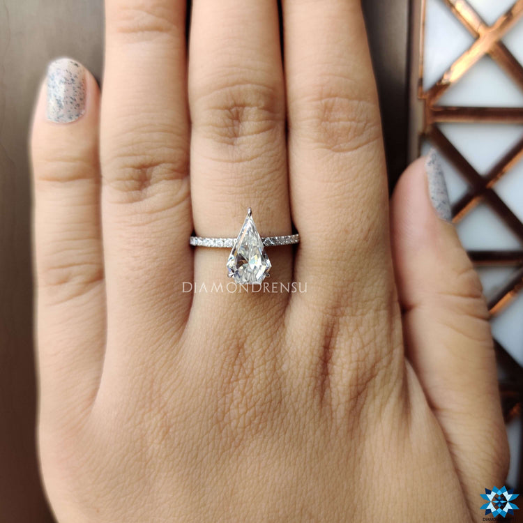 Elegant moissanite engagement ring with custom spear shape.
