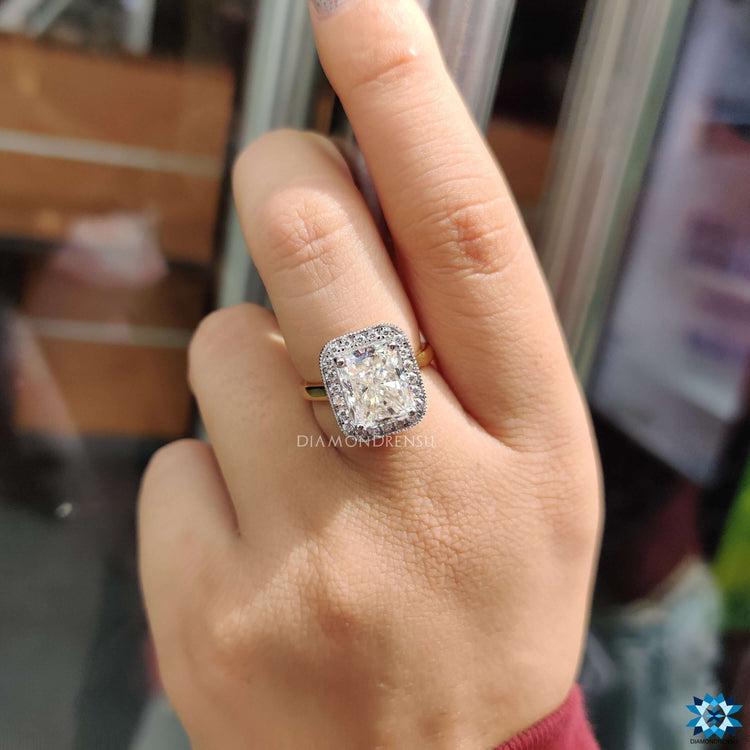 Custom moissanite ring in yellow gold with halo design.
