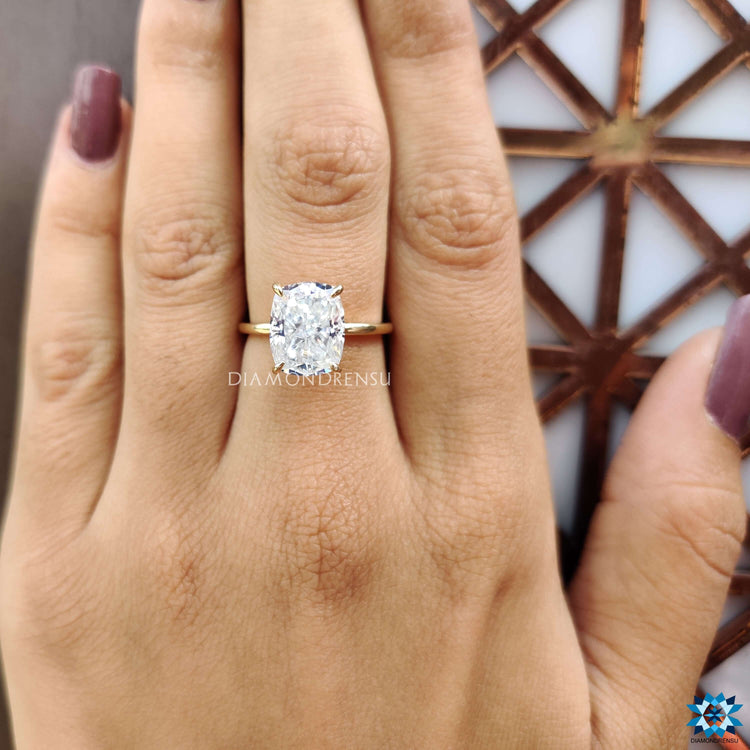 Moissanite engagement ring with a solitaire setting in yellow gold.
