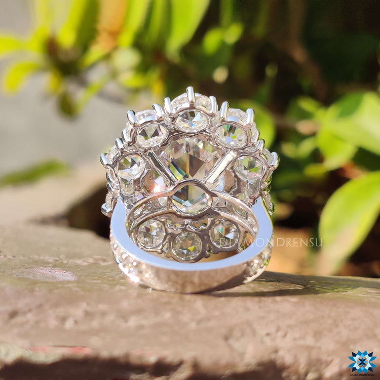 White gold engagement ring with round rose cut halo and fishtail prongs.