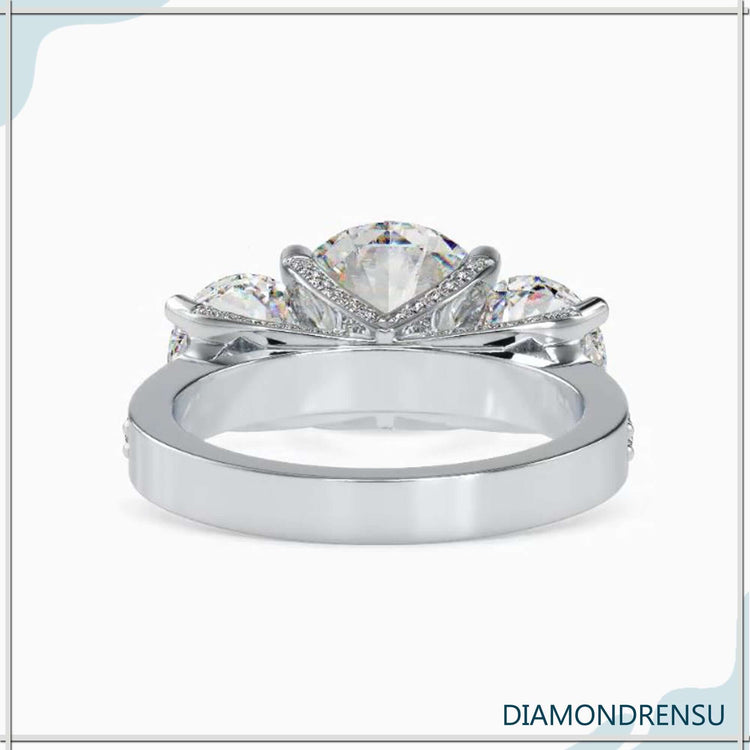 Yellow gold ring with round diamond side stones, handmade in UK.
