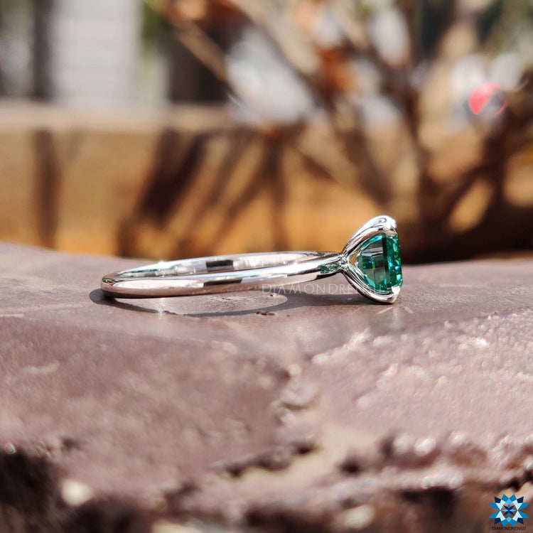 White gold ring featuring emerald cut moissanite.
