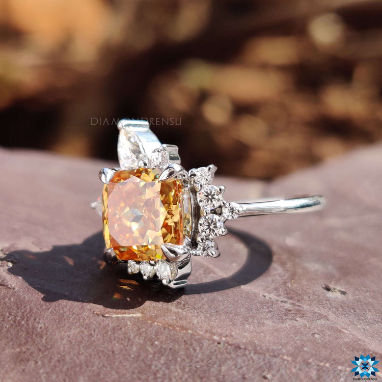 Cushion Rensu cut champagne moissanite ring in custom white gold design.
