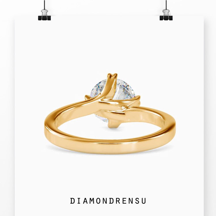 Handmade engagement ring with round diamond in gold finish.
