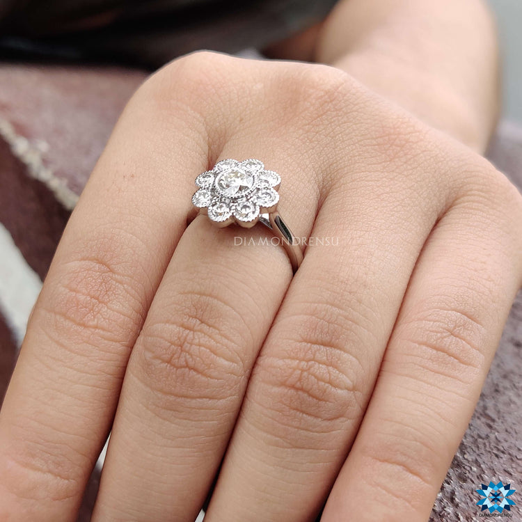 Handmade engagement ring with bezel and halo setting in cathedral style.
