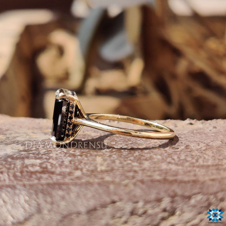 Black moissanite ring with 4 prong claw setting.
