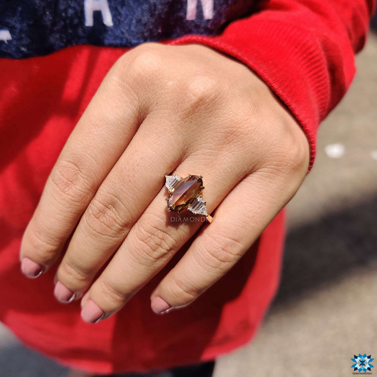 Custom engagement ring with mixed shape side stones.
