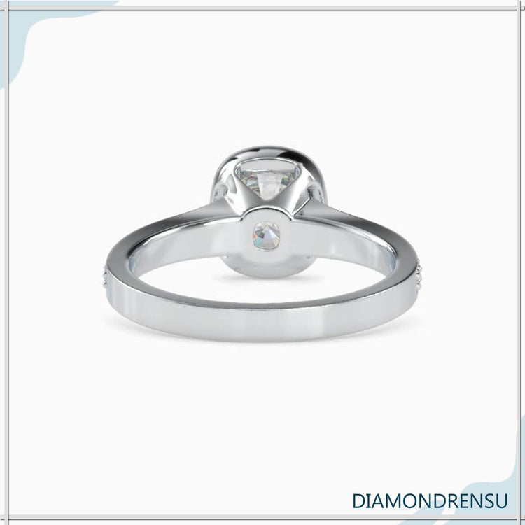 Simple diamond ring with cushion cut and custom bezel.
