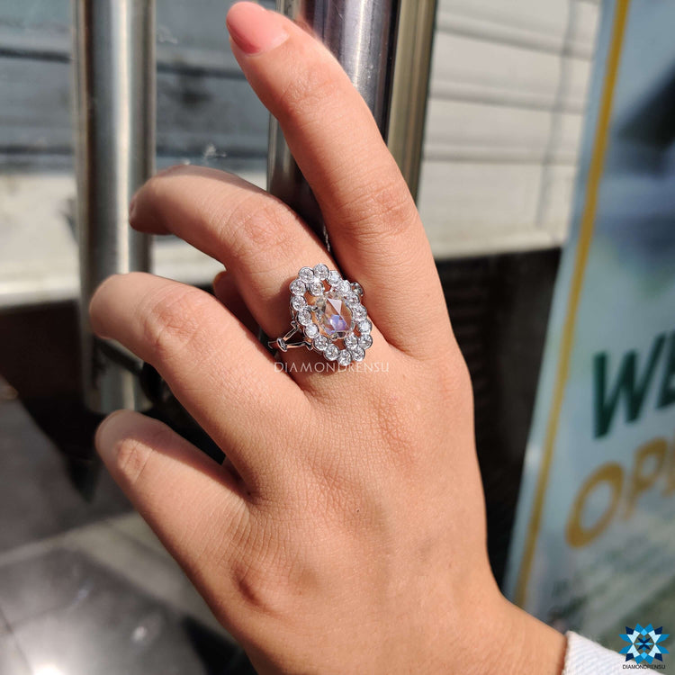 Moissanite engagement ring designed with oval centre and halo finish.
