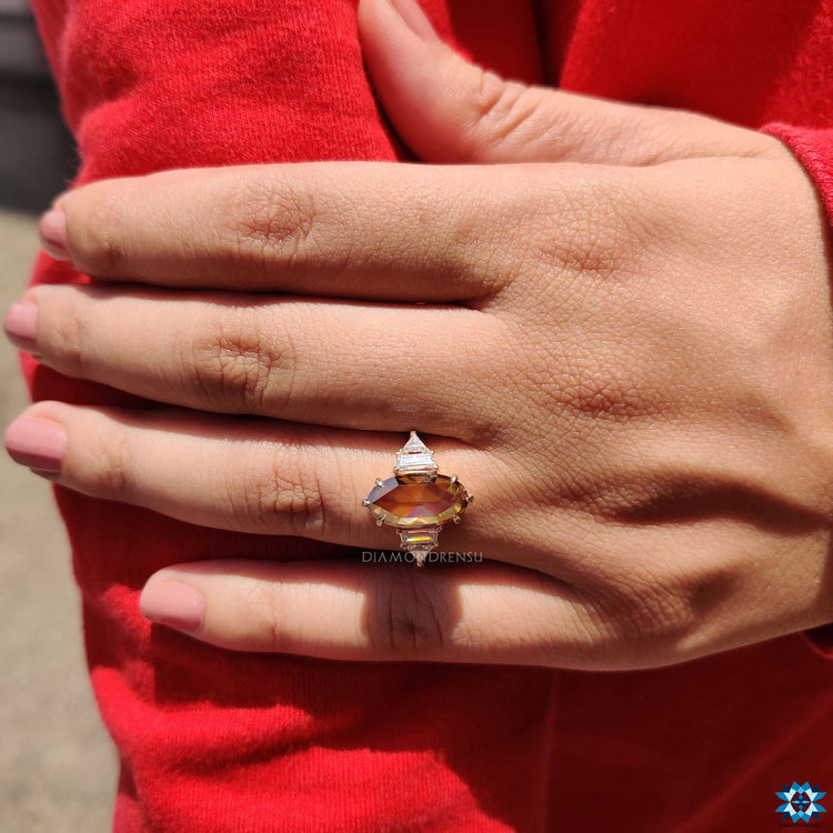 Moissanite engagement ring with warm champagne tone.
