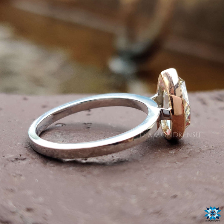 Bezel set pear rose cut moissanite ring.
