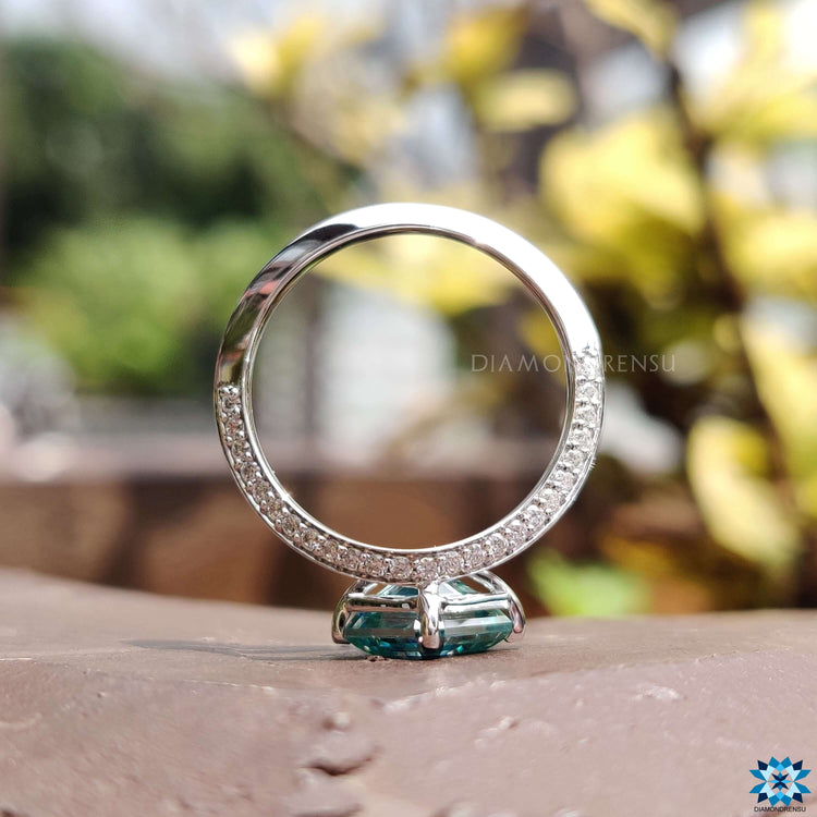 Custom engagement ring with cyan blue center stone.
