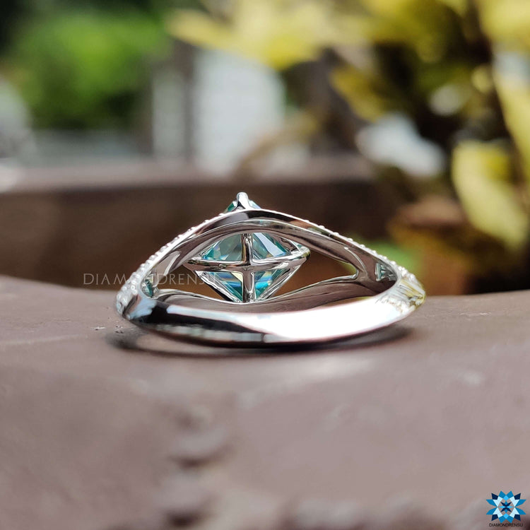 Asscher cut moissanite ring with open pave design.
